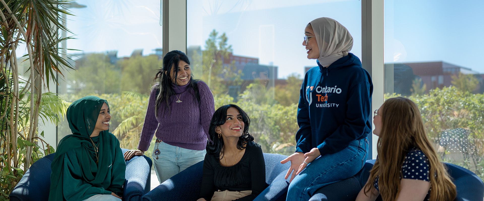 Group of female students hanging out in a campus building