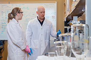 Student with prof in lab